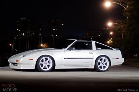 A White Sports Car Parked On The Street At Night