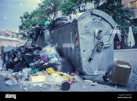 Garbage Container Overflowing In A City Street Stock Photo Alamy