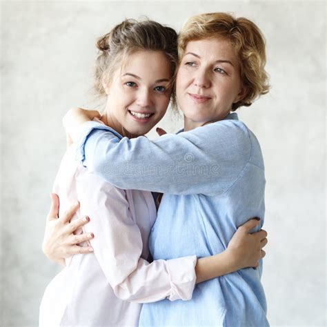 lifestyle and people concept happy senior mother embracing adult daughter laughing together