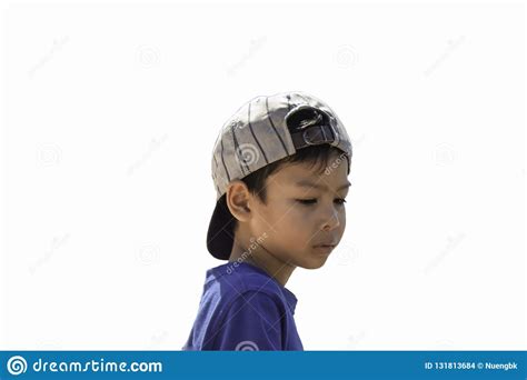 A Boy Wearing A Winter Jacket And Hat Standing On The