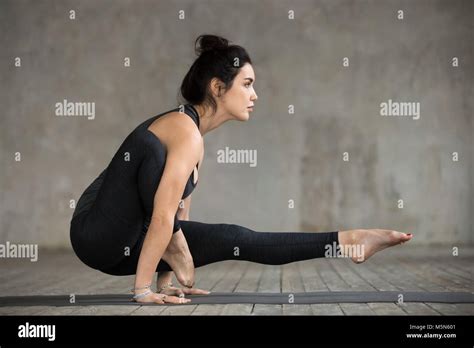 Young Sporty Woman Practicing Yoga Doing Leg Over Shoulder Exercise