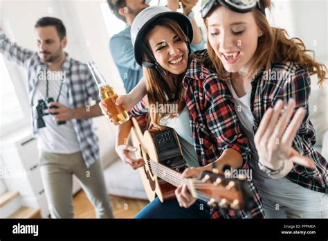 Cheerful Friends Having Party Together And Playing Instruments Stock