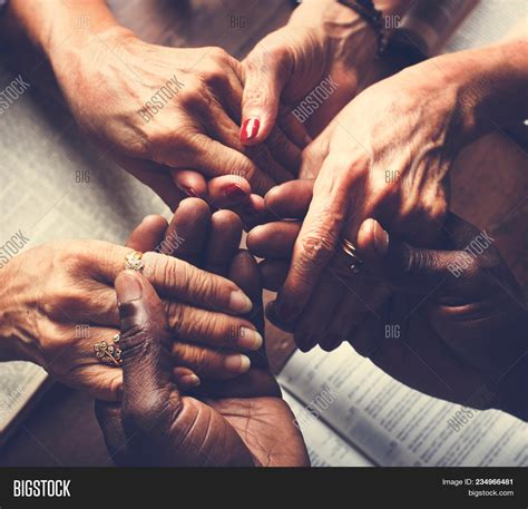 People Praying Together Holding Hands