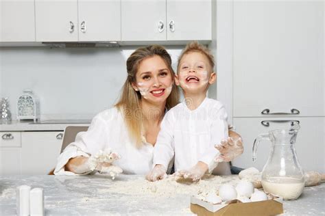 Mom And Boy In The Kitchen Smeared Their Face With Flour Stock Image