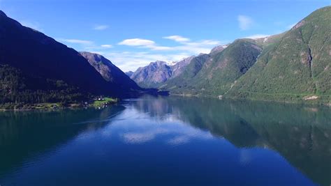 Mountain Peaks Reflecting In The Calm Waters Of Beautiful Norwegian