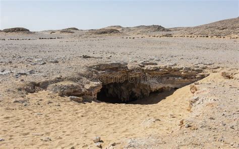 Barren Rocky Desert Landscape In Hot Climate With Cave Entrance Stock