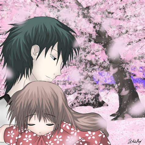 Two People Standing In Front Of A Tree With Pink Flowers On It And One