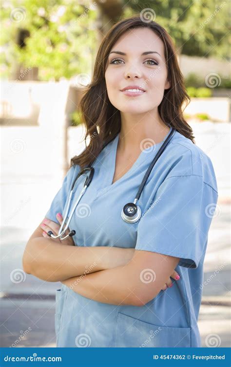 Proud Young Adult Woman Doctor Or Nurse Portrait Outside Stock Photo