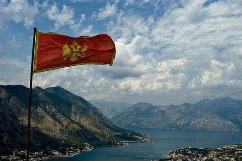 Flag of Montenegro over Kotor Bay | Tour around the world, Montenegro