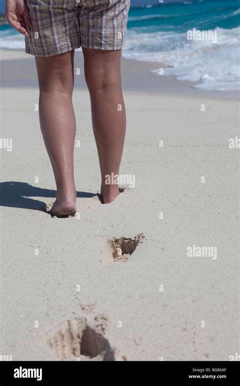 View Of A Womans Legs Wearing Shorts On The Beach In The Caribbean