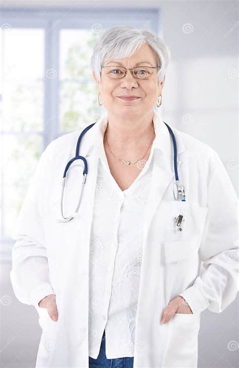 Senior Female Doctor Smiling At Hospital Corridor Stock Image Image