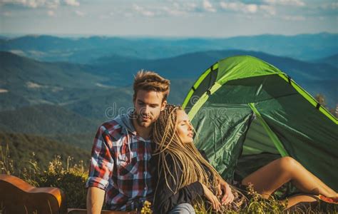 Romantic Couple Camping Outdoors And Sitting Near Tent Happy Man And