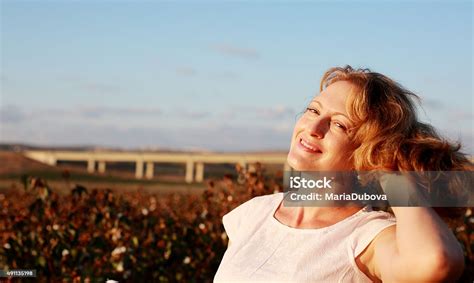 Portrait Of Beautiful 35 Years Old Woman On Sunset Colors Stock Photo
