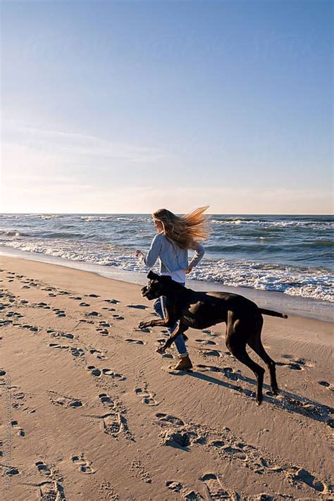 Girl Running With Her Dog By Stocksy Contributor Danil Nevsky