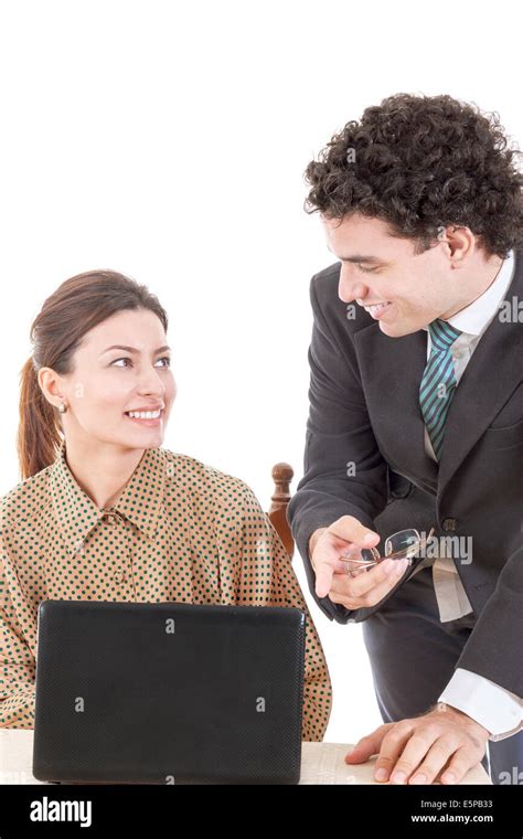 happy boss and smiling secretary working together on laptop computer showing something on