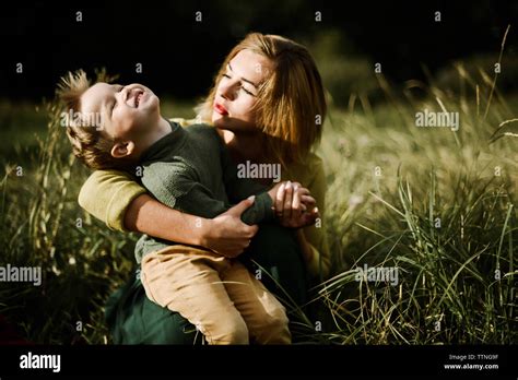 Young Mother Hugs Her Little Pretty Son Outdoor Stock Photo Alamy