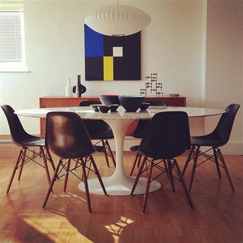 Chip & scratch resistant white glossy fiberglass top dining table. The Bloom that Doesn't Fade: Saarinen's Tulip Table and Chairs