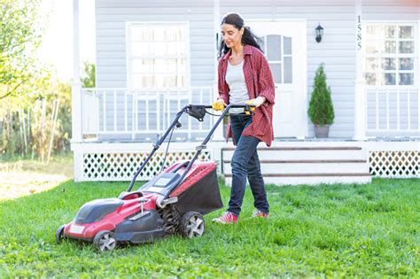 Mid Women Using A Lawn Mower In Her Backyard Stock Photo Download