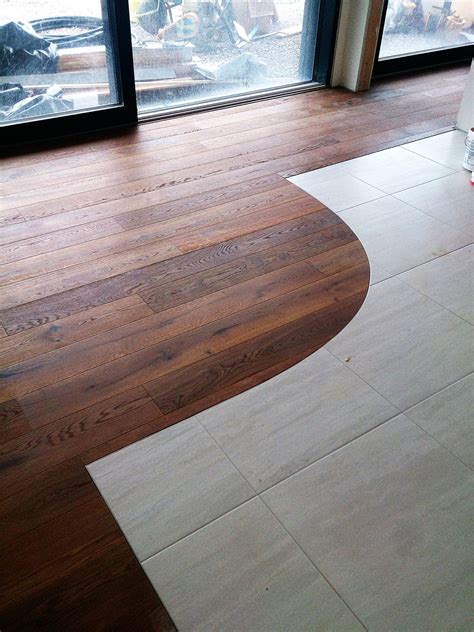 Walnut Engineered Floor Combined With Ceramic Tile Being Fitted By
