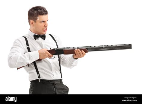 Angry Young Man Shooting With A Shotgun Isolated On White Background