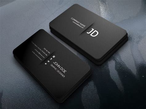 Two Black Business Cards Sitting On Top Of A Table