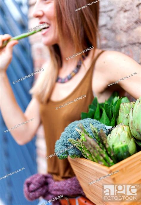 Smiling Woman Holding Basket With Fresh Vegetables Stock Photo Picture And Royalty Free Image