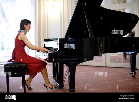 Woman In A Red Dress Playing A Grand Piano Stock Photo 111714035 Alamy