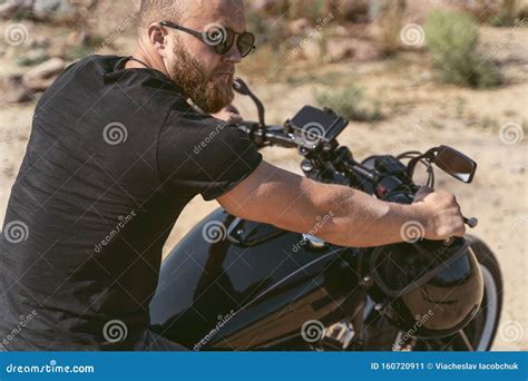 Back View Of A Fit And Muscular Biker Sitting On His Bike Stock Image