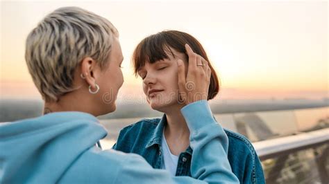 Close Up Of Young Sensual Lesbian Couple Enjoying Romantic Moments While Standing On The Bridge