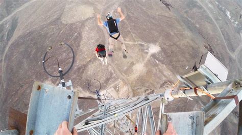 daredevil performs an amazing nine front flips while base jumping off a tower base jumping