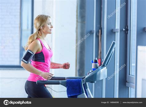 Sporty Woman On Treadmill Stock Photo By ©arturverkhovetskiy 148846095