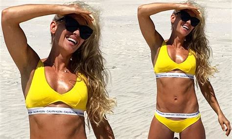 former biggest loser trainer tiffiny hall shows off her ripped abs in a yellow bikini