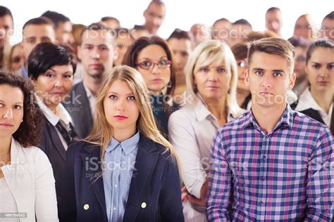Large Group Of Serious Business People Looking At The Camera Stock
