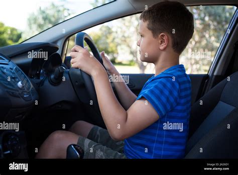 Side View Of Teenage Boy Driving A Car Stock Photo Alamy