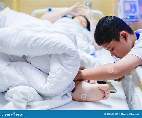 The Son Is Taking Care Of The Sick Mother On The Hospital Bed The Boy