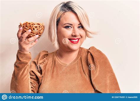 Beautiful Plus Size Woman Holding Bowl With German Baked Pretzels Over
