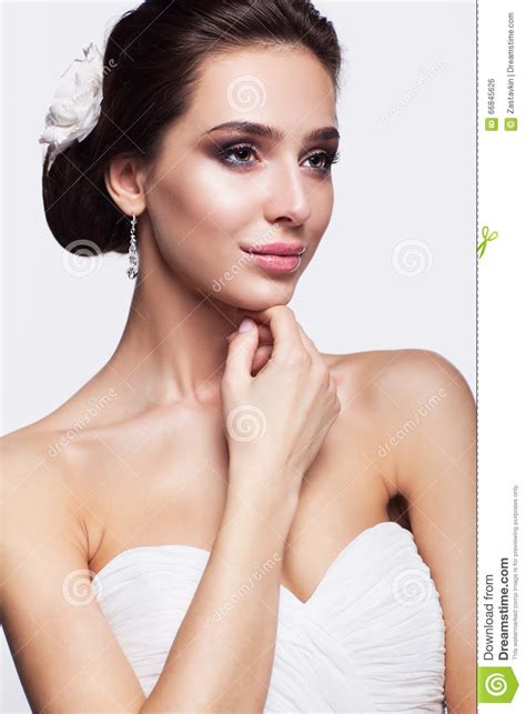 Portrait Of Beautiful Young Brunette Woman Bride In White