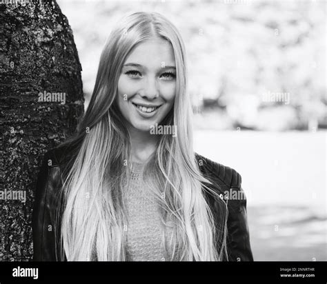Outdoor Portrait Of Teenage Girl With Long Blond Hair In Black And