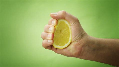 Hand Squeezing Lemon On White Background Stock Footage Video 2054387