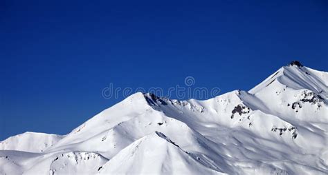 Panoramic View On Snowy Winter Mountains And Clear Blue Sky In S Stock
