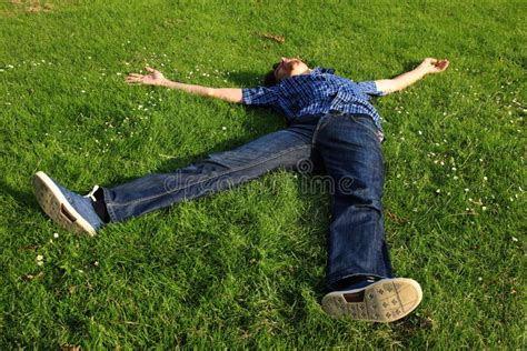 A Guy Lying On A Grass Field Stock Image Image Of Playful Looking