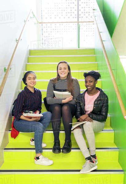 Portrait Smiling Confident High School Girls Sitting On Stairs Stock