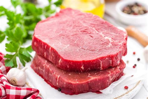Raw Uncooked Beef Meat Steaks On White Wooden Background Close Up
