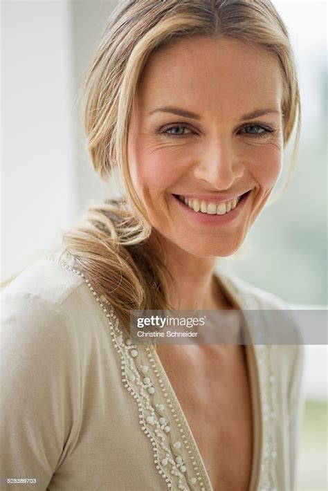Mature Blonde Woman Looking At Camera Smiling Portrait Bildbanksbilder