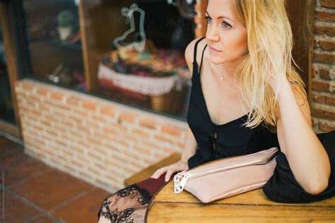 blonde woman sitting in a restaurant by stocksy contributor jovo jovanovic stocksy
