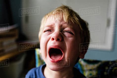Close Up Of Boy Crying At Home Stock Photo Dissolve