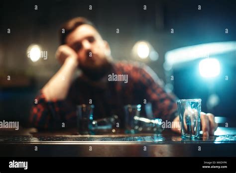 drunk man sleeps at the bar counter alcohol addiction male person in pub alcoholism stock