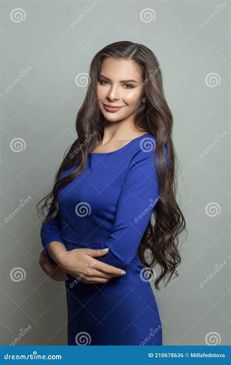 Pretty Smiling Brunette Woman Wearing Blue Dress On White Background