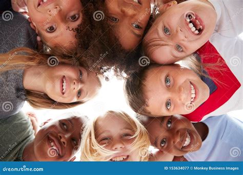 Group Of Multi Cultural Children With Friends Looking Down Into Camera