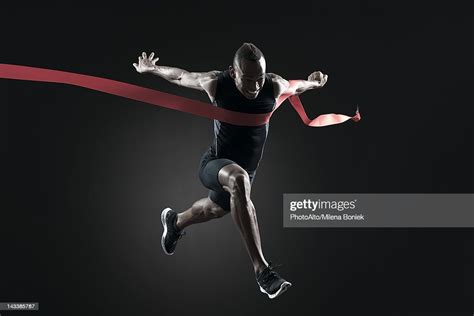 Runner Crossing Finish Line High Res Stock Photo Getty Images